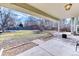 The covered patio overlooks a spacious yard with mature trees and well-manicured landscaping at 7118 W Elmhurst Ave, Littleton, CO 80128