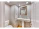 Charming powder room with pedestal sink and mosaic tile accent wall at 7118 W Elmhurst Ave, Littleton, CO 80128