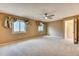 Spacious bedroom with plush carpeting, ceiling fan, and large windows for natural light at 7118 W Elmhurst Ave, Littleton, CO 80128