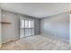 Neutral bedroom with ample natural light and a window with white shutters at 7118 W Elmhurst Ave, Littleton, CO 80128