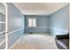 Blue bedroom with carpeted floors, white trim, and natural light at 7118 W Elmhurst Ave, Littleton, CO 80128