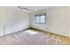 Sun-filled bedroom with carpeted floors, a window, and modern lighting fixture at 7118 W Elmhurst Ave, Littleton, CO 80128