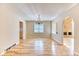 Dining room boasting hardwood floors, modern chandelier, and arched doorway at 7118 W Elmhurst Ave, Littleton, CO 80128