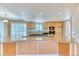 Modern kitchen showcasing an island with granite countertops, wood cabinetry, and recessed lighting at 7118 W Elmhurst Ave, Littleton, CO 80128