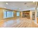 Spacious living room boasting hardwood floors, stone fireplace, and bright bay windows at 7118 W Elmhurst Ave, Littleton, CO 80128