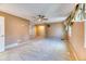 Comfortable living room with neutral carpet, built-in shelving, and ample natural light at 7118 W Elmhurst Ave, Littleton, CO 80128