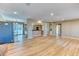 Open-concept living room with hardwood floors seamlessly connects to the kitchen and dining area at 7118 W Elmhurst Ave, Littleton, CO 80128