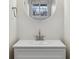 Clean, modern bathroom with sleek fixtures, a circular mirror, and a large window at 10174 Spotted Owl Ave, Highlands Ranch, CO 80129