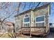 Back of house with wooden deck and fenced in yard at 10174 Spotted Owl Ave, Highlands Ranch, CO 80129