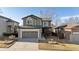 Two-story home featuring a well-maintained front yard and an attached two-car garage at 10174 Spotted Owl Ave, Highlands Ranch, CO 80129