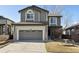 Charming two-story home featuring an attached two car garage and landscaped front yard at 10174 Spotted Owl Ave, Highlands Ranch, CO 80129