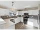 Modern kitchen featuring white cabinets, stainless steel appliances, and a stylish backsplash at 10174 Spotted Owl Ave, Highlands Ranch, CO 80129