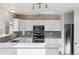 Well-lit kitchen boasts white cabinets, stainless steel appliances, and stone backsplash at 10174 Spotted Owl Ave, Highlands Ranch, CO 80129