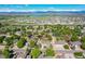 Expansive aerial view of a single Gathering home with a large garden, mountain views, and proximity to a lake at 2151 Burbank St, Berthoud, CO 80513