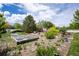 Expansive backyard with lush gardens, mature trees, and serene landscaping at 2151 Burbank St, Berthoud, CO 80513