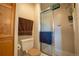 Bathroom featuring a glass shower and a toilet with wood trim at 2151 Burbank St, Berthoud, CO 80513