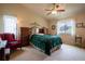 Bright bedroom featuring a ceiling fan, large window, and a comfortable green blanket at 2151 Burbank St, Berthoud, CO 80513