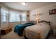 Bedroom featuring two twin beds, carpet, wall sconces, a window with natural light, and room for storage at 2151 Burbank St, Berthoud, CO 80513