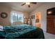 Bedroom boasts a view to the bath, large window, and green coverlet on the bed at 2151 Burbank St, Berthoud, CO 80513