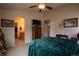 Vaulted primary bedroom features a dresser with TV, and entrance to the en suite bath at 2151 Burbank St, Berthoud, CO 80513
