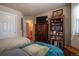 Spare bedroom featuring a bookshelf and view to an adjacent bath at 2151 Burbank St, Berthoud, CO 80513