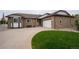 Charming brick home featuring a well-maintained lawn, spacious driveway, and an attached two-car garage at 2151 Burbank St, Berthoud, CO 80513