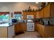 Well-equipped kitchen with wood cabinets, granite countertops, and stainless steel appliances at 2151 Burbank St, Berthoud, CO 80513