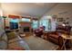A well-lit living room with vaulted ceilings, a fireplace, and comfortable leather seating at 2151 Burbank St, Berthoud, CO 80513