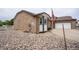Image showcasing side of home with brick, concrete, and gravel landscaping with white picket fence at 2151 Burbank St, Berthoud, CO 80513