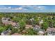 Birds eye view of a home surrounded by mature trees and other houses in a lush green neighborhood at 7655 S Ogden Way, Centennial, CO 80122
