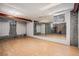 Spacious basement with wood flooring and a mirrored wall, ready for customization at 7655 S Ogden Way, Centennial, CO 80122