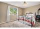 Cozy bedroom featuring a decorative iron bed frame, a window, and neutral-toned walls at 7655 S Ogden Way, Centennial, CO 80122