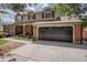 Charming two-story home with a brick facade and a well-manicured lawn and a two car garage at 7655 S Ogden Way, Centennial, CO 80122