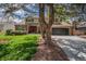 Beautiful two-story home featuring a brick facade, an attached garage and a well-manicured lawn at 7655 S Ogden Way, Centennial, CO 80122