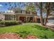 Charming two-story home with a well-manicured lawn and mature trees at 7655 S Ogden Way, Centennial, CO 80122