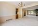 Spacious living room featuring a decorative chandelier, neutral carpet and large windows at 7655 S Ogden Way, Centennial, CO 80122