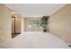 Bright living room with three large windows offering ample natural light and neutral carpeting at 7655 S Ogden Way, Centennial, CO 80122