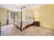 Comfortable bedroom featuring a four-poster bed, window, and nightstand at 7655 S Ogden Way, Centennial, CO 80122