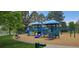 Playground with slides, climbing structures, and a safe play area surrounded by trees at 7655 S Ogden Way, Centennial, CO 80122