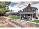 Large backyard featuring a garden area, patio with outdoor seating, and well-maintained lawn at 8581 W Hinsdale Pl, Littleton, CO 80128