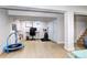 Finished basement featuring a home office area, exercise equipment, and ample storage space at 8581 W Hinsdale Pl, Littleton, CO 80128