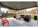 Stylish covered patio with comfortable seating, an outdoor grill, and ambient string lights at 8581 W Hinsdale Pl, Littleton, CO 80128