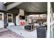 Relaxing covered patio with outdoor furniture, TV, and string lights, ideal for outdoor gatherings at 8581 W Hinsdale Pl, Littleton, CO 80128