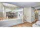 Bright dining area with modern lighting, wooden floors, and an open view into the living area at 8581 W Hinsdale Pl, Littleton, CO 80128