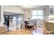 Dining area with a round table, comfortable seating, and natural light from a bright window at 8581 W Hinsdale Pl, Littleton, CO 80128