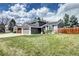 Charming two-story home featuring a well-manicured lawn, gray siding, white brick accents and an attached garage at 8581 W Hinsdale Pl, Littleton, CO 80128