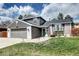 Charming two-story home with a manicured lawn, brick accents, and a well-maintained gray siding at 8581 W Hinsdale Pl, Littleton, CO 80128