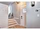 Charming foyer with a front door, accent wall, and stairs leading to the upper level at 8581 W Hinsdale Pl, Littleton, CO 80128