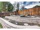 Backyard garden with raised beds and retaining walls, perfect for growing your own fruits and vegetables at 8581 W Hinsdale Pl, Littleton, CO 80128