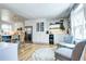 Bright kitchen showcases a built-in coffee bar area, stainless steel refrigerator, and sleek hardwood floors at 8581 W Hinsdale Pl, Littleton, CO 80128